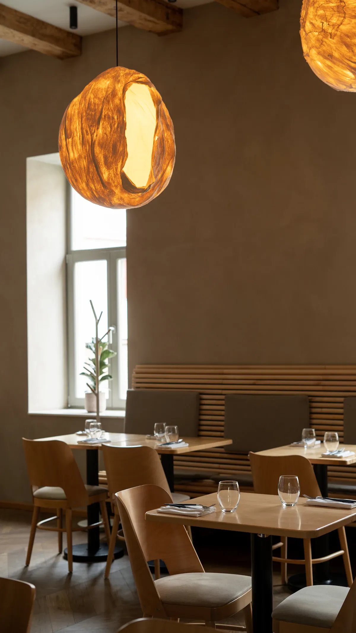 Quiet tables by a tall window