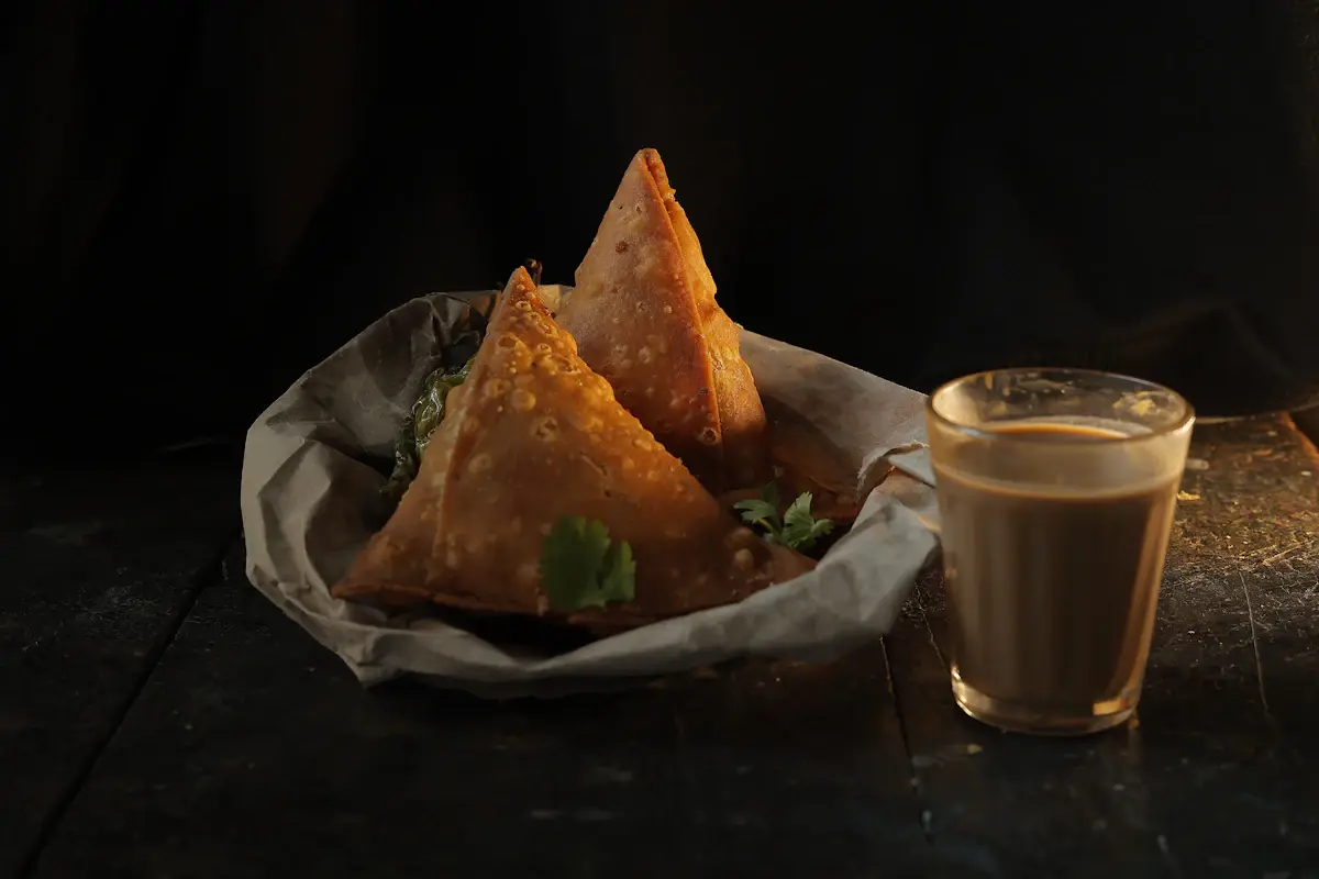 Golden fried pastries on a dark plate